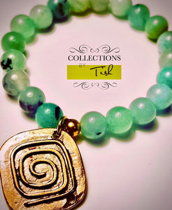 Gorgeous sea glass-colored agate unit with a brass charm.